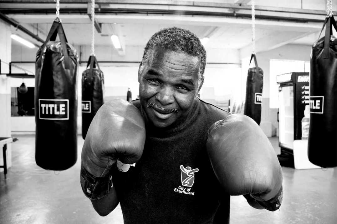 Trainer checking heavy bag hardware